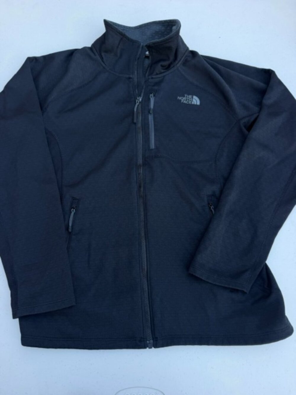 North Face women's jacket in size medium Black zipper and pockets.